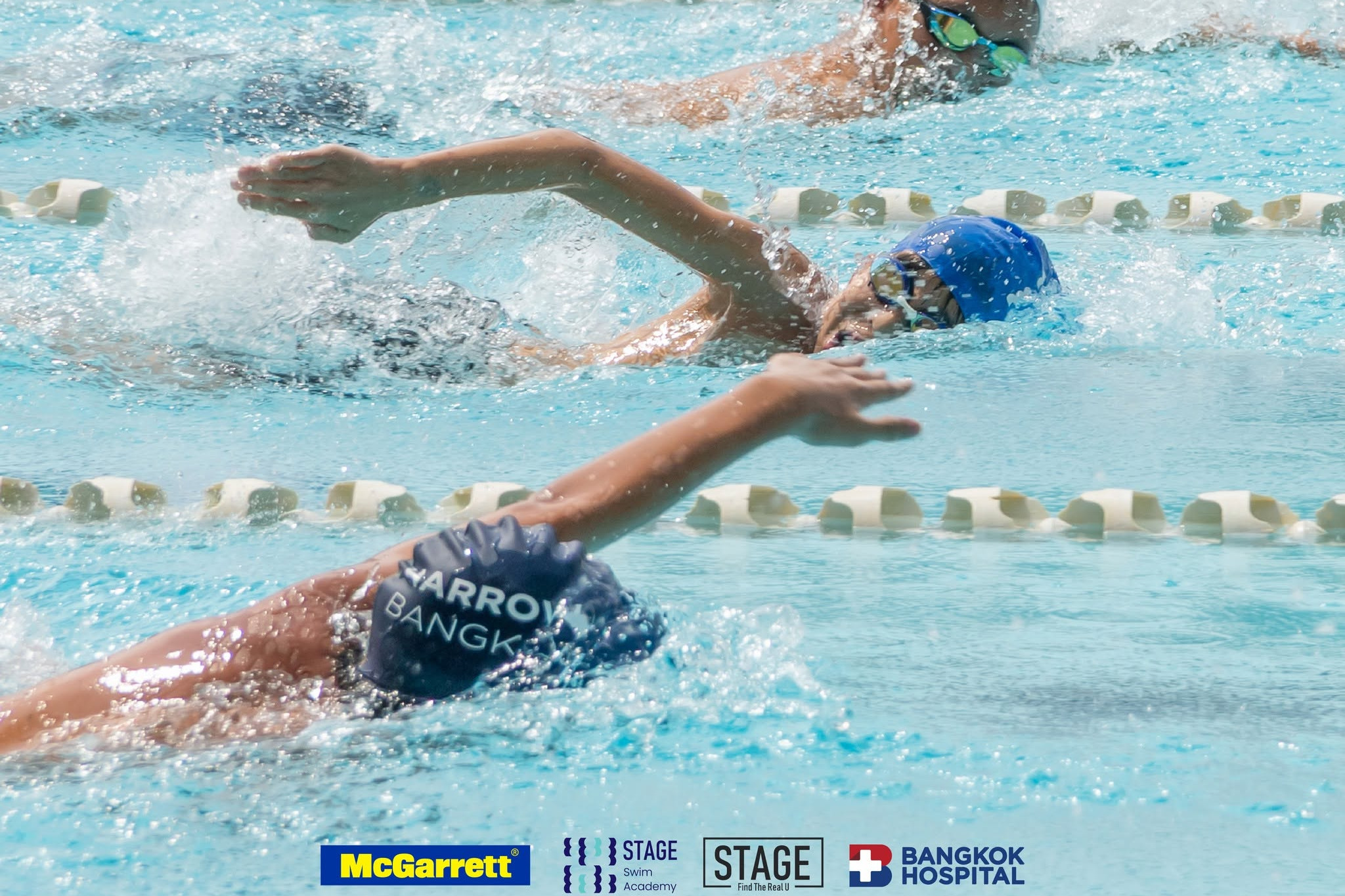 Swim squad racing freestyle in the STAGE lanes