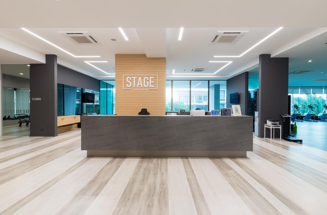 STAGE reception desk with the STAGE logo on the wall